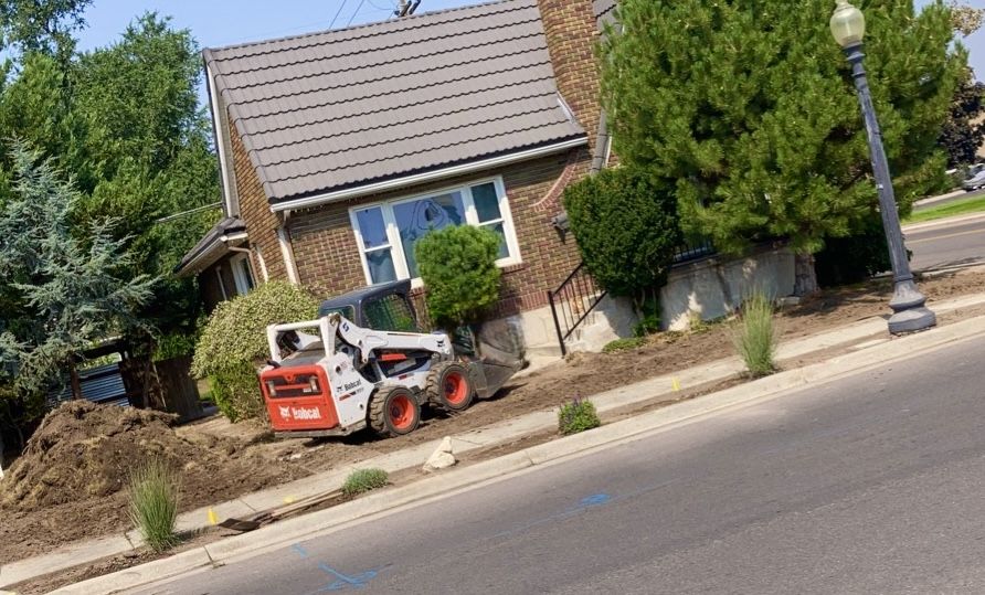 Sod removal in progress with a skid steer