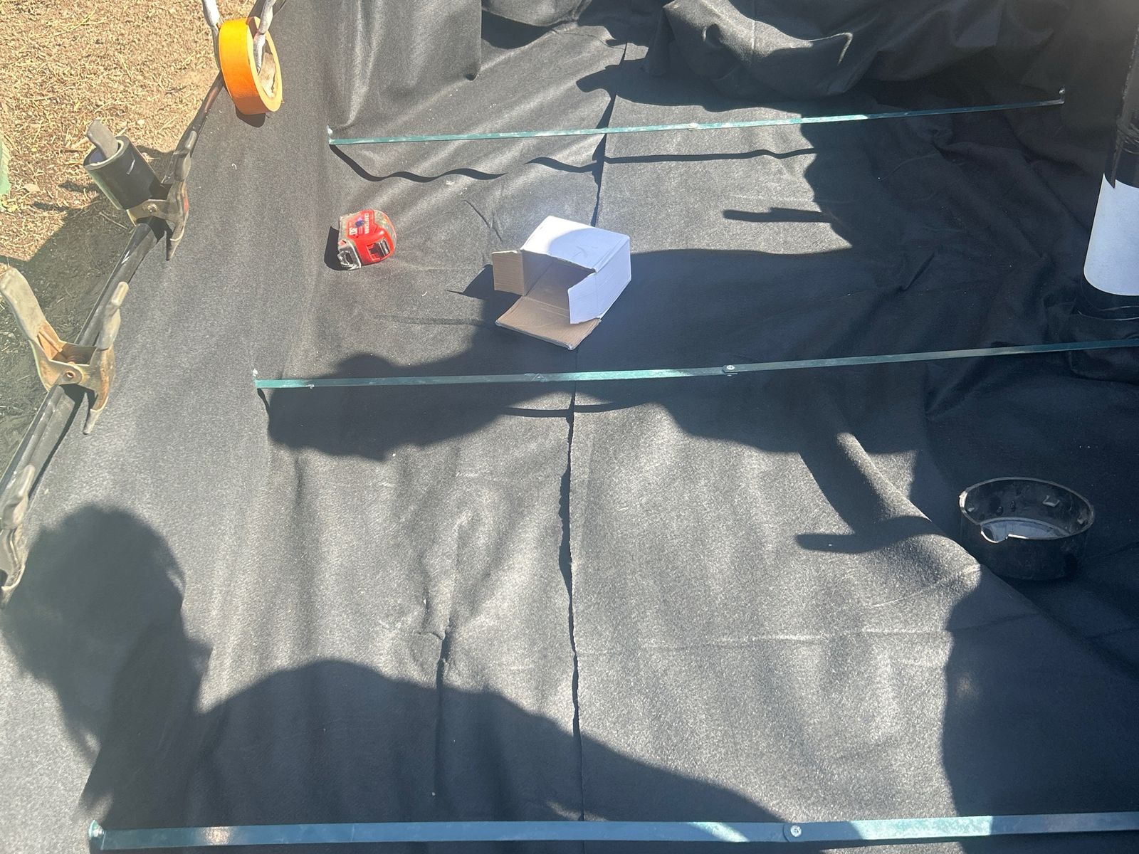 Overhead view of geotextile fabric lining a raised bed before the rock goes in